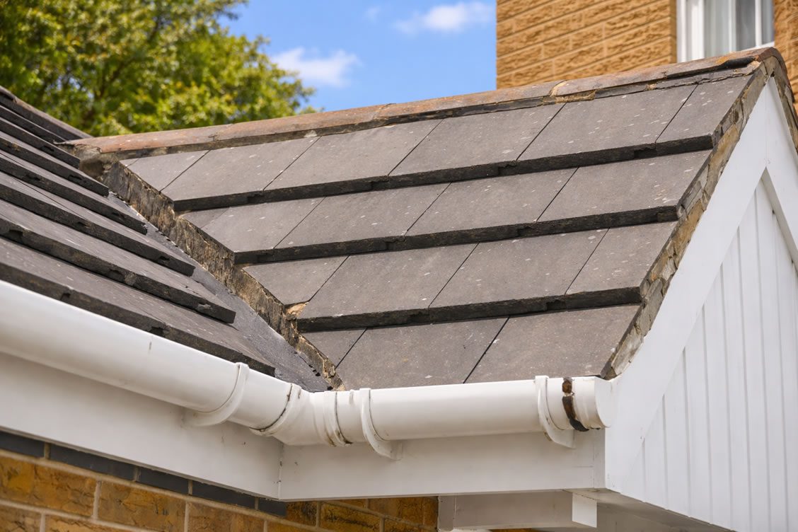 roof corner repairs with white guttering