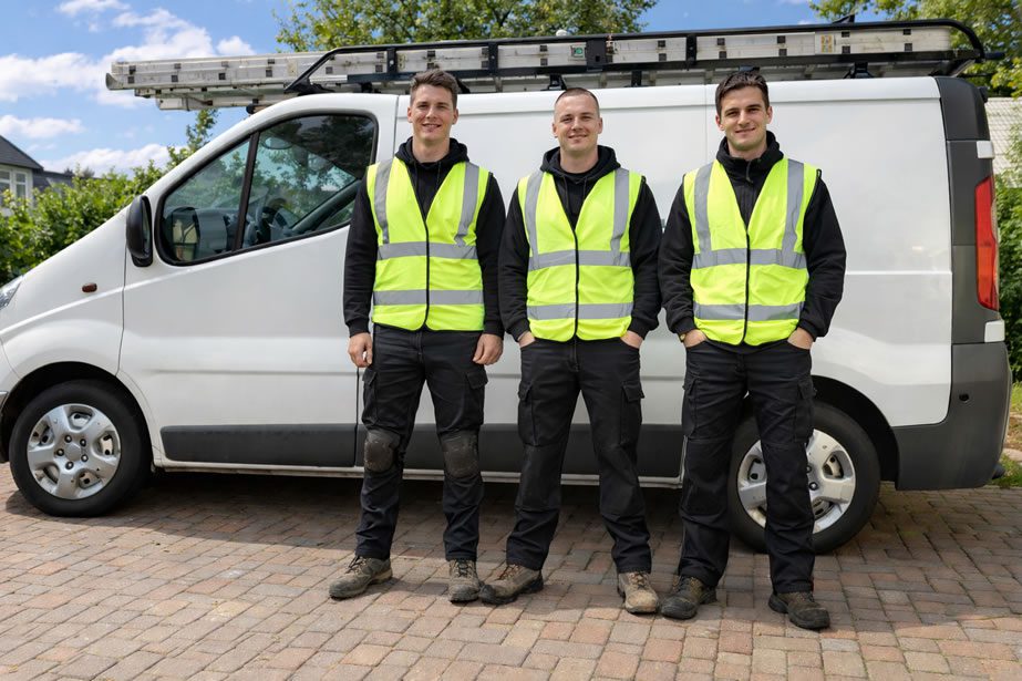 how to choose a roofer - roofers next to a van