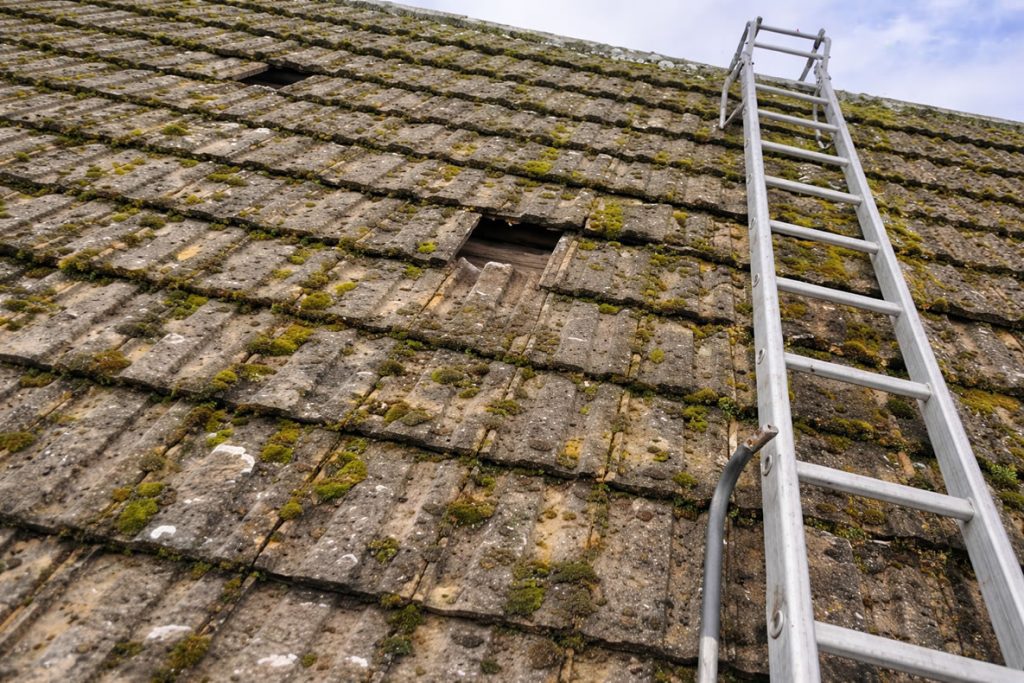 leaking roof repairs missing roof tiles ladder on roof