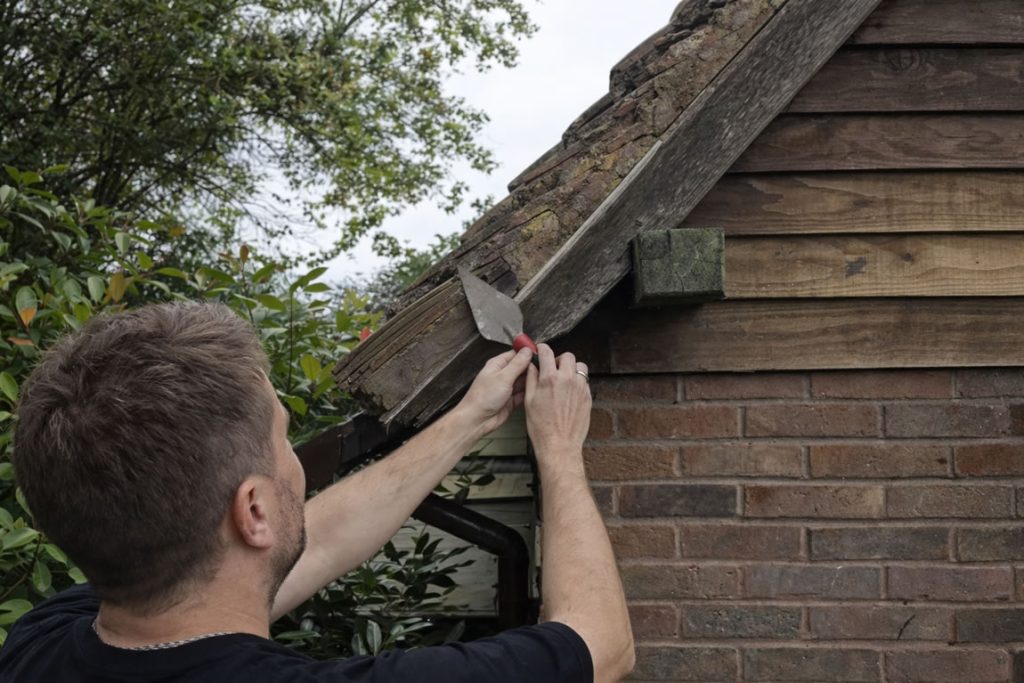 repairing roof verge with cement mix