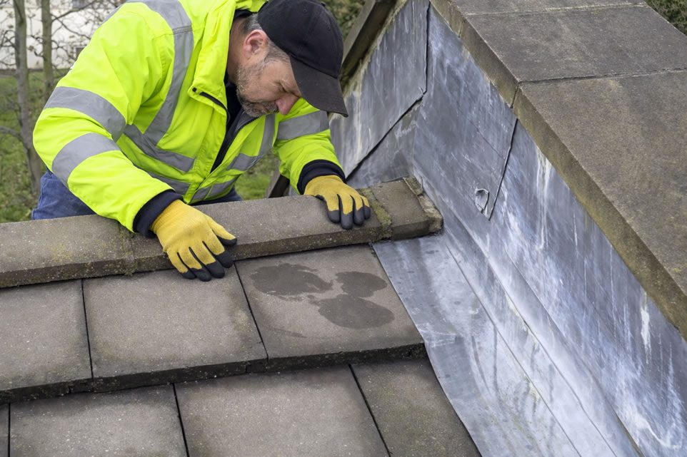 roofer inspecting for ridge tile movement