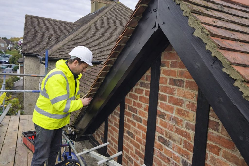 roofer inspecting roof repairs