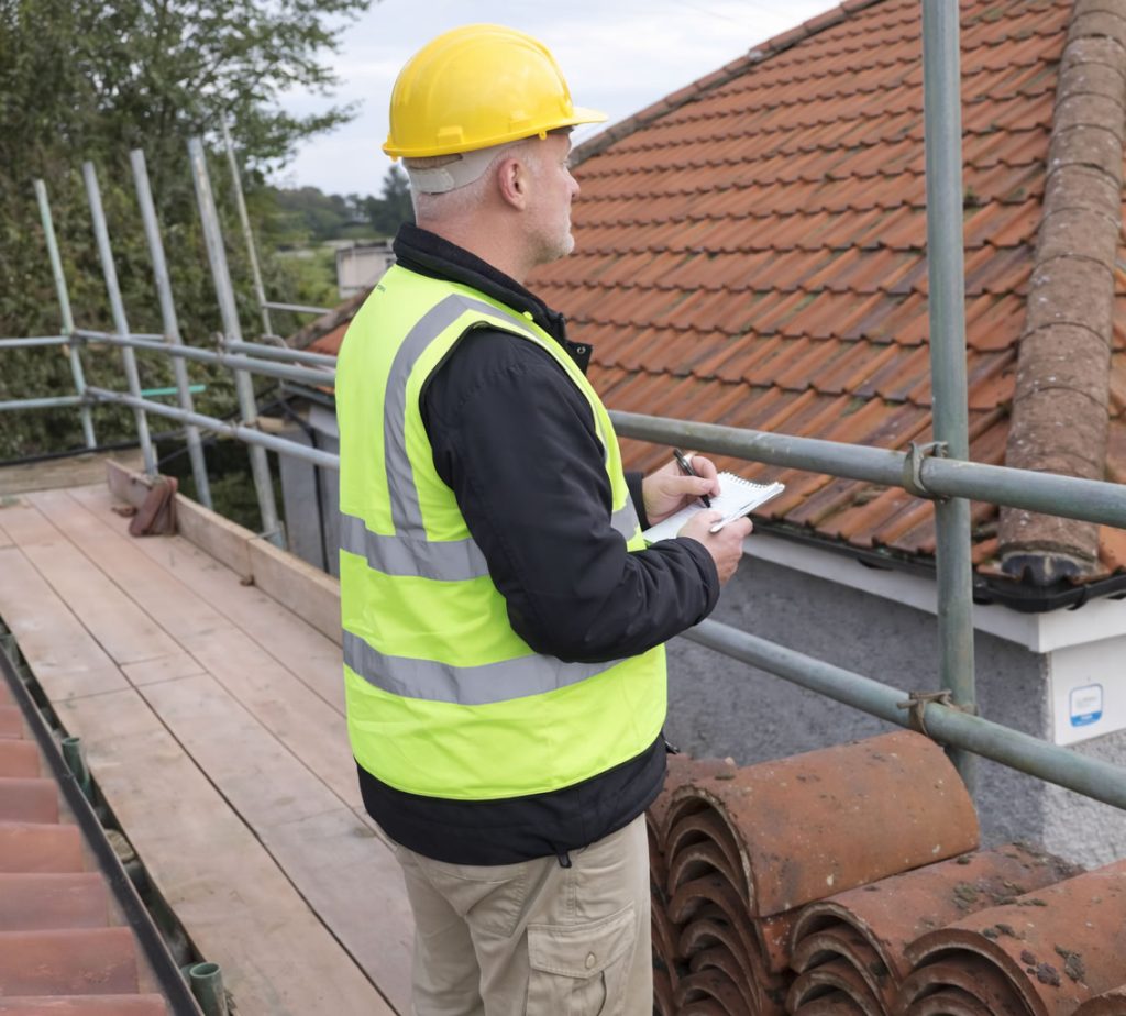 roofer working out roof repair cost in uk for a tile roof